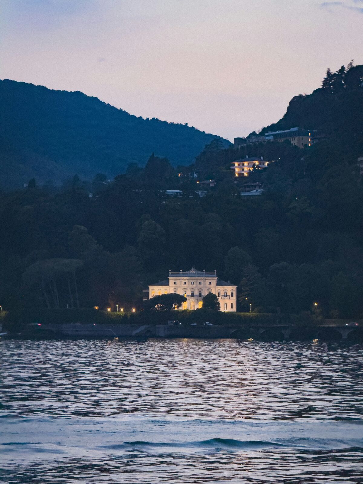 Lake Como shoreline and villa illuminated at dusk