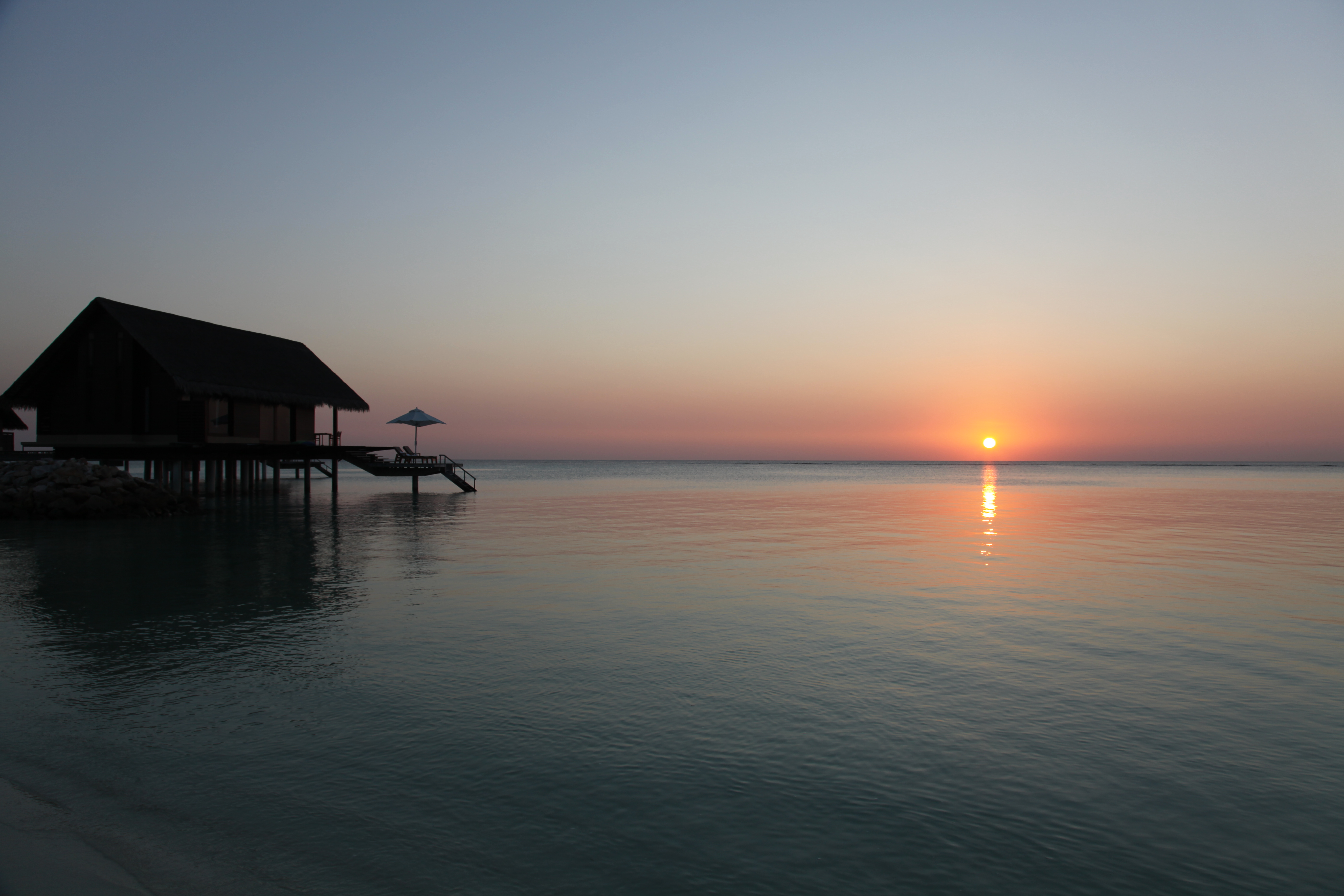 Overwater villa and sunset at Reethi Rah, Maldives