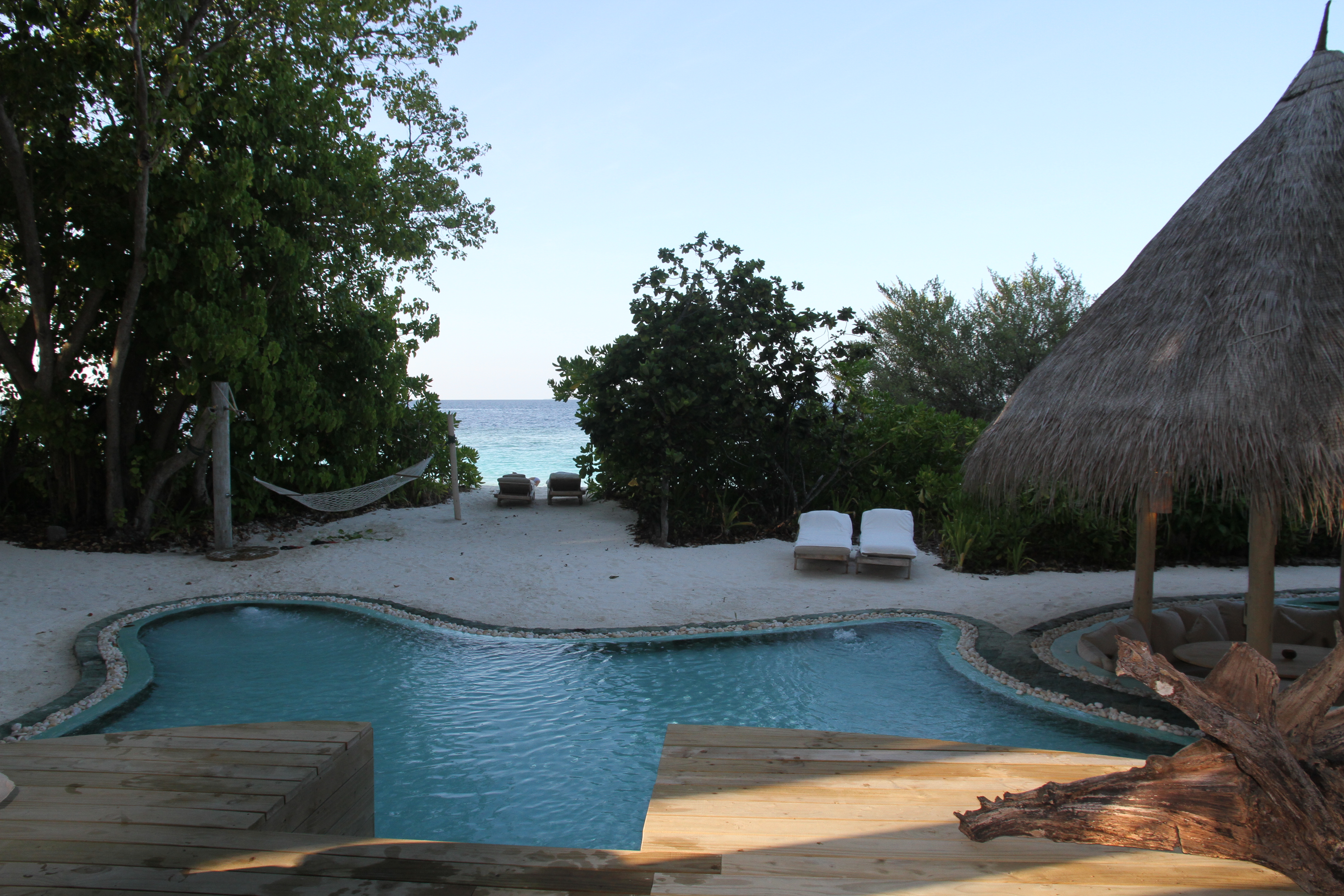 Private pool, thatched pavilion and sea view at Soneva Fushi